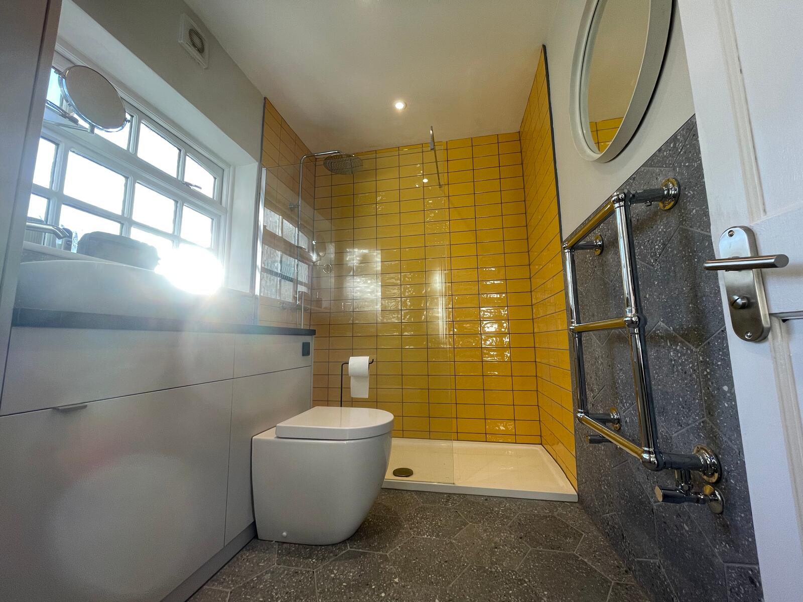Walk-in shower with yellow tiles